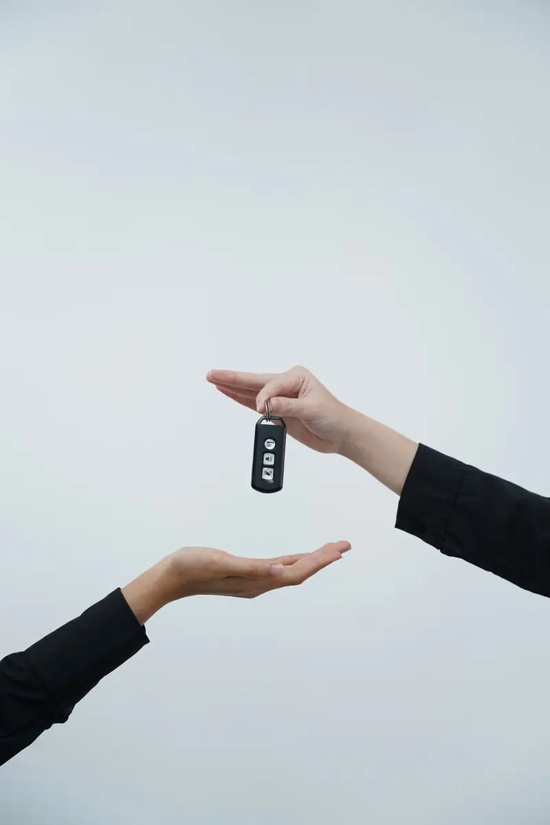 A car key being handed over